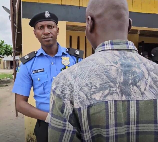 The Police Public Relations Officer of Delta State Command, SP Bright Edafe, with the suspect (backing camera).